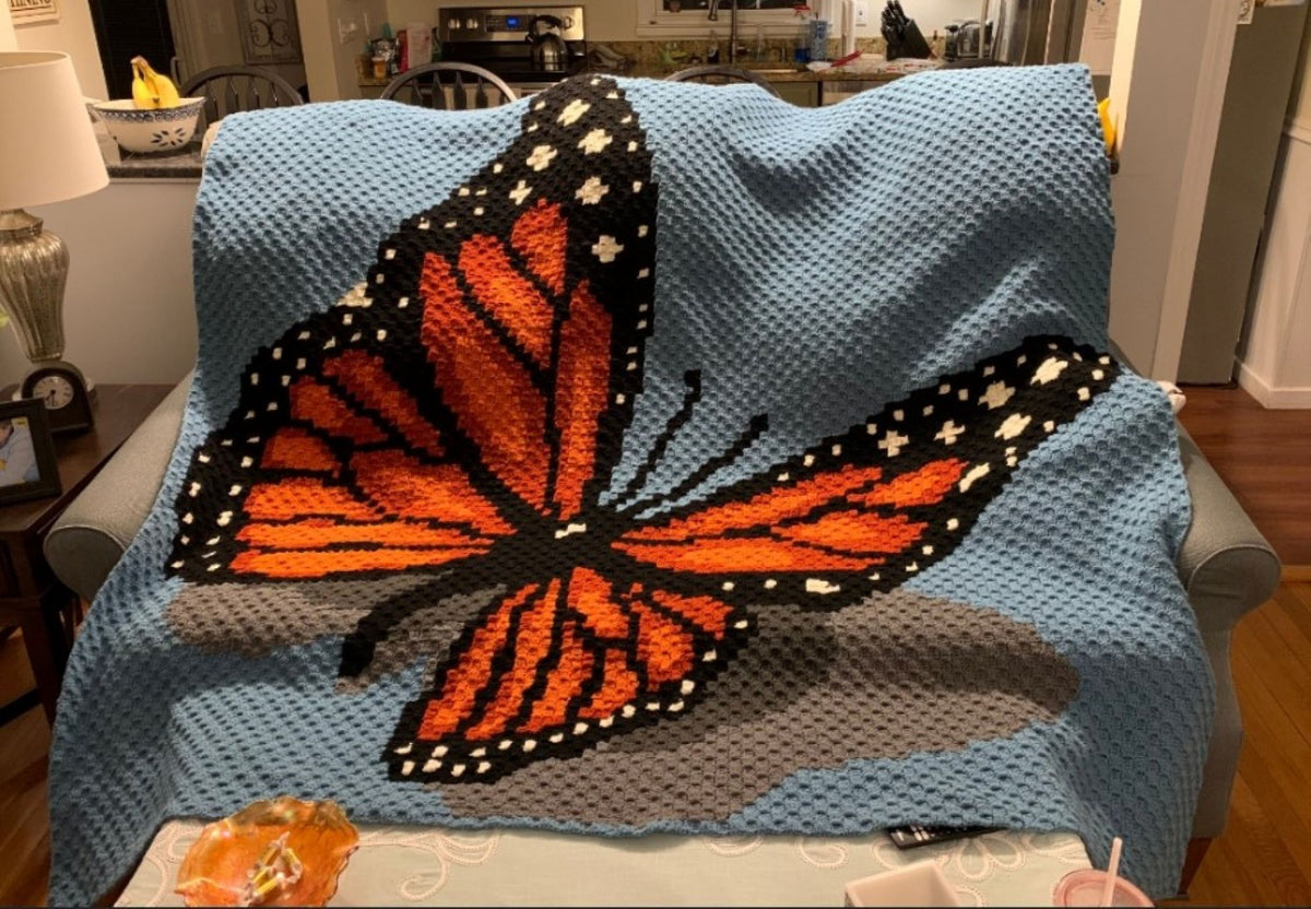 Butterfly C2C crochet graphgan pattern featuring a bright monarch design for garden lovers and animal crochet fans.
Crochet monarch butterfly blanket pattern with written instructions, color chart, and nature-inspired design.