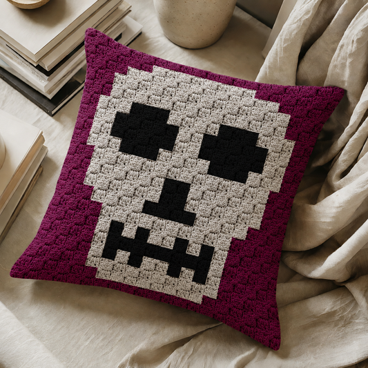 C2C crochet pillow pattern with written instructions featuring a white skull graph design for Halloween and gothic home decor.