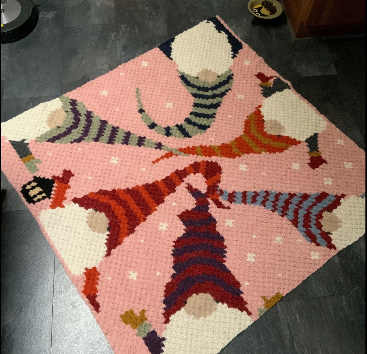 Holiday gnome crochet blanket pattern with colorful winter gnomes, snowflakes, and Christmas decorations.
C2C Christmas crochet pattern featuring several gnomes in red, pink, purple, yellow, and orange hats.