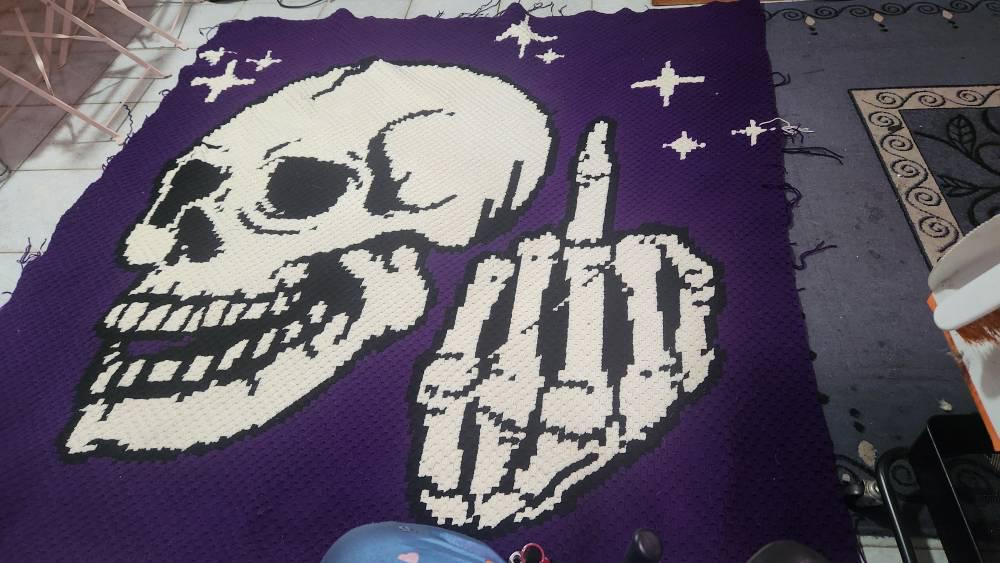 Add a bold, cheeky touch to your crochet collection with this Middle Finger Skeleton C2C Crochet Pattern. The design features a detailed skull with a raised middle finger and small star accents, making it perfect for funny adult crochet projects, gothic decor, Halloween makes, rebellious gifts, and statement blankets.