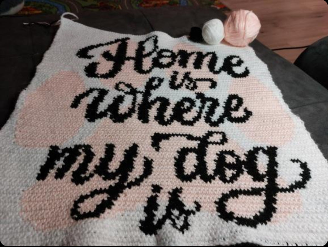 Paw print tapestry crochet pattern for dog moms, dog dads, pet lovers, and handmade home decor.
Crochet dog quote graph pattern with yellow paws, black lettering, and white background.