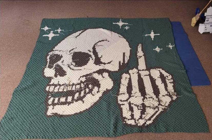 Add a bold, cheeky touch to your crochet collection with this Middle Finger Skeleton C2C Crochet Pattern. The design features a detailed skull with a raised middle finger and small star accents, making it perfect for funny adult crochet projects, gothic decor, Halloween makes, rebellious gifts, and statement blankets.