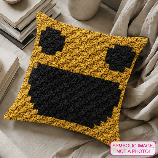 C2C crochet pillow pattern with written instructions featuring a yellow smiley face graph design for cheerful handmade home decor.