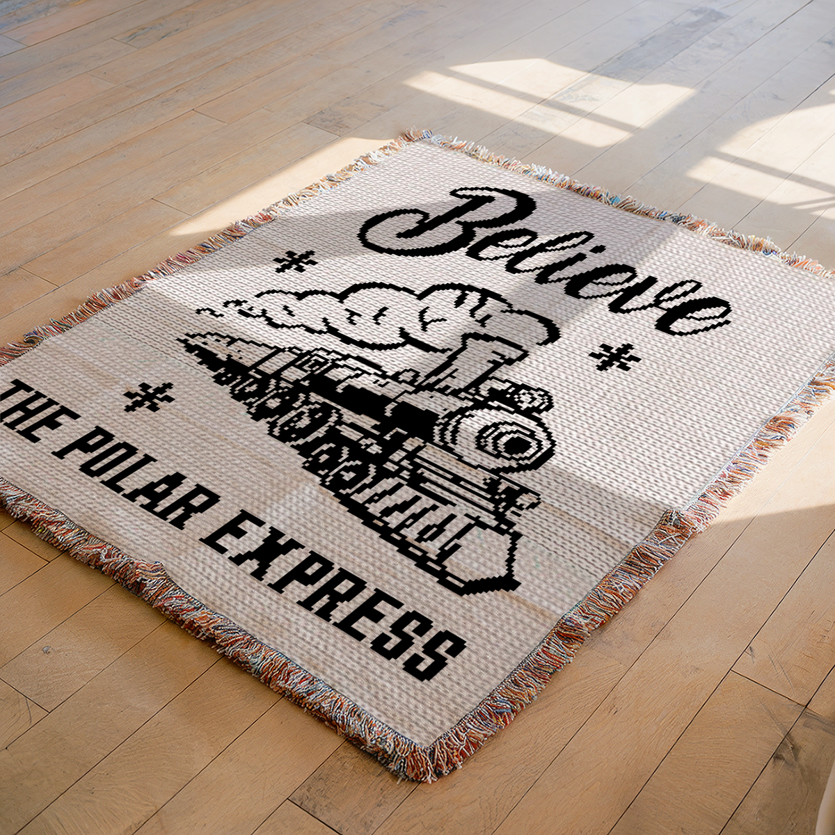 Believe Polar Train SC crochet blanket pattern shown on a wooden floor with vintage steam train design