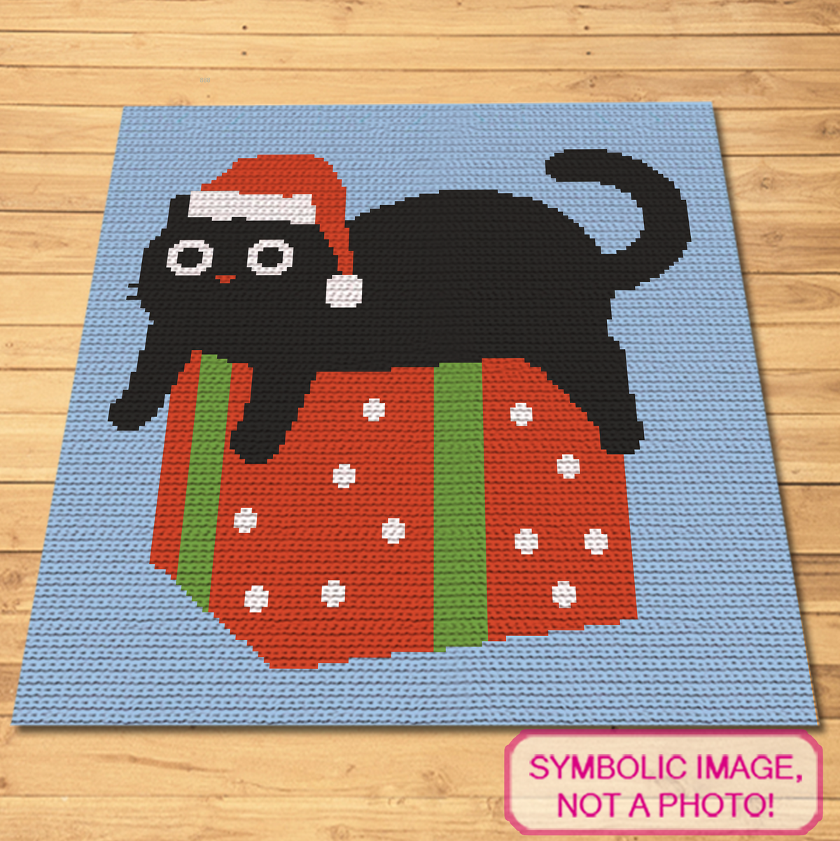 Christmas cat crochet blanket pattern with black cat in Santa hat sitting on a wrapped gift