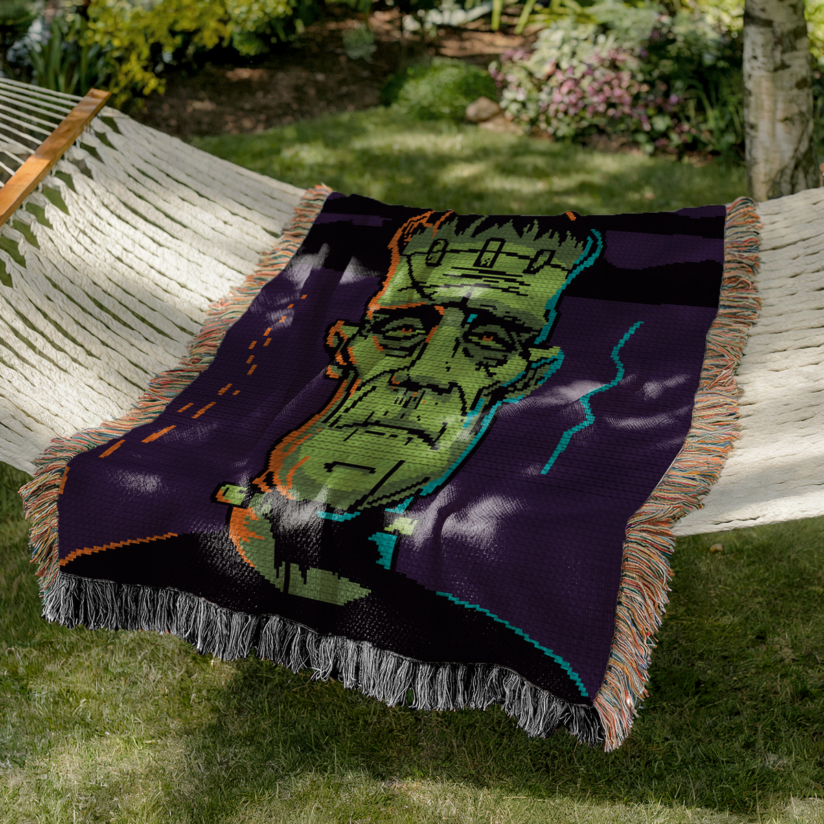 Frankenstein monster crochet blanket mockup in green, violet, black, orange and blue for Halloween decor.