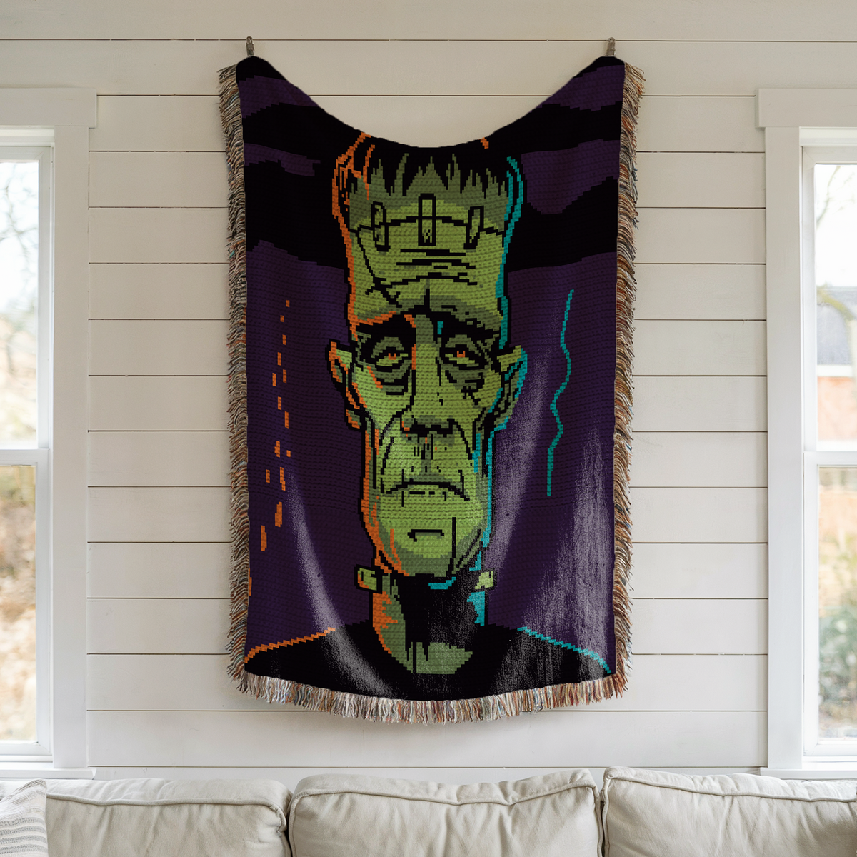 Frankenstein monster crochet afghan displayed as a gothic Halloween wall hanging.