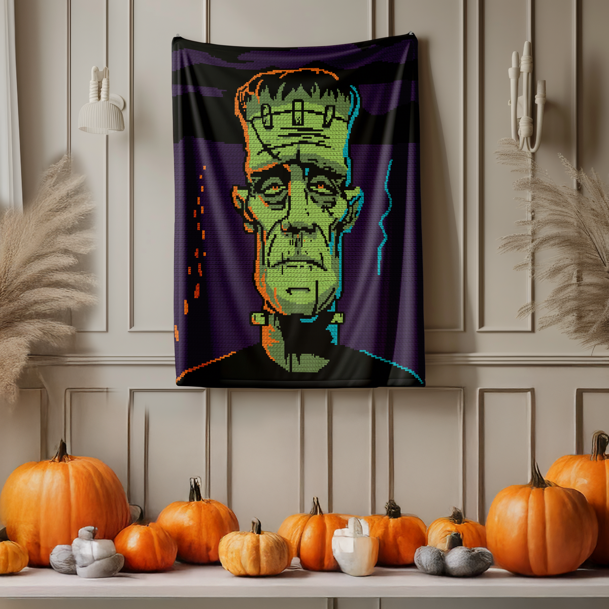 Frankenstein monster tapestry crochet blanket pattern displayed vertically with Halloween pumpkins below.