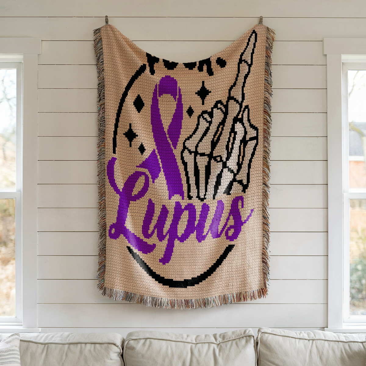 Fuck Lupus crochet blanket displayed on wall with purple awareness ribbon and skeleton middle finger design