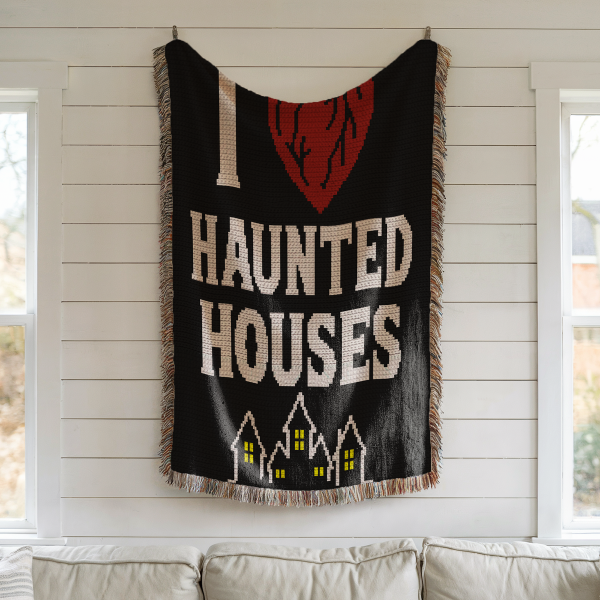 I Heart Haunted Houses SC crochet blanket displayed as spooky Halloween wall decor in a bright room.