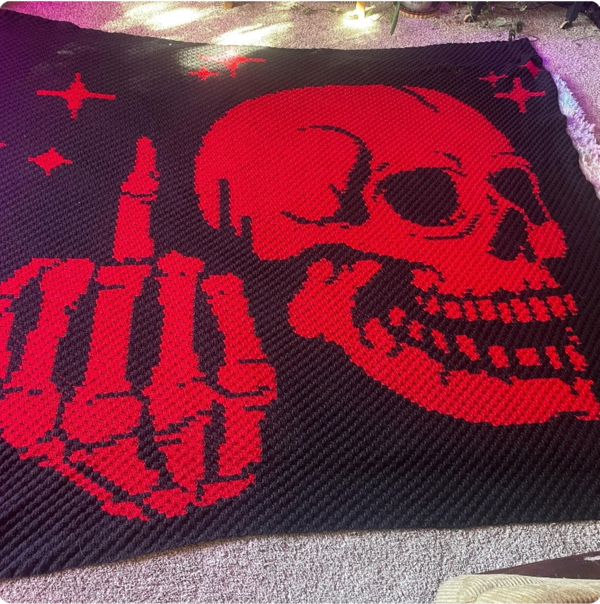 Finished Middle Finger Skeleton C2C crochet blanket in red and black
