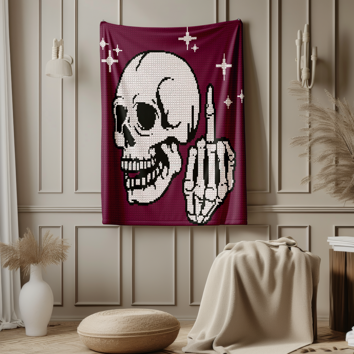 Styled interior image of the Middle Finger Skeleton crochet blanket hanging in a beige room