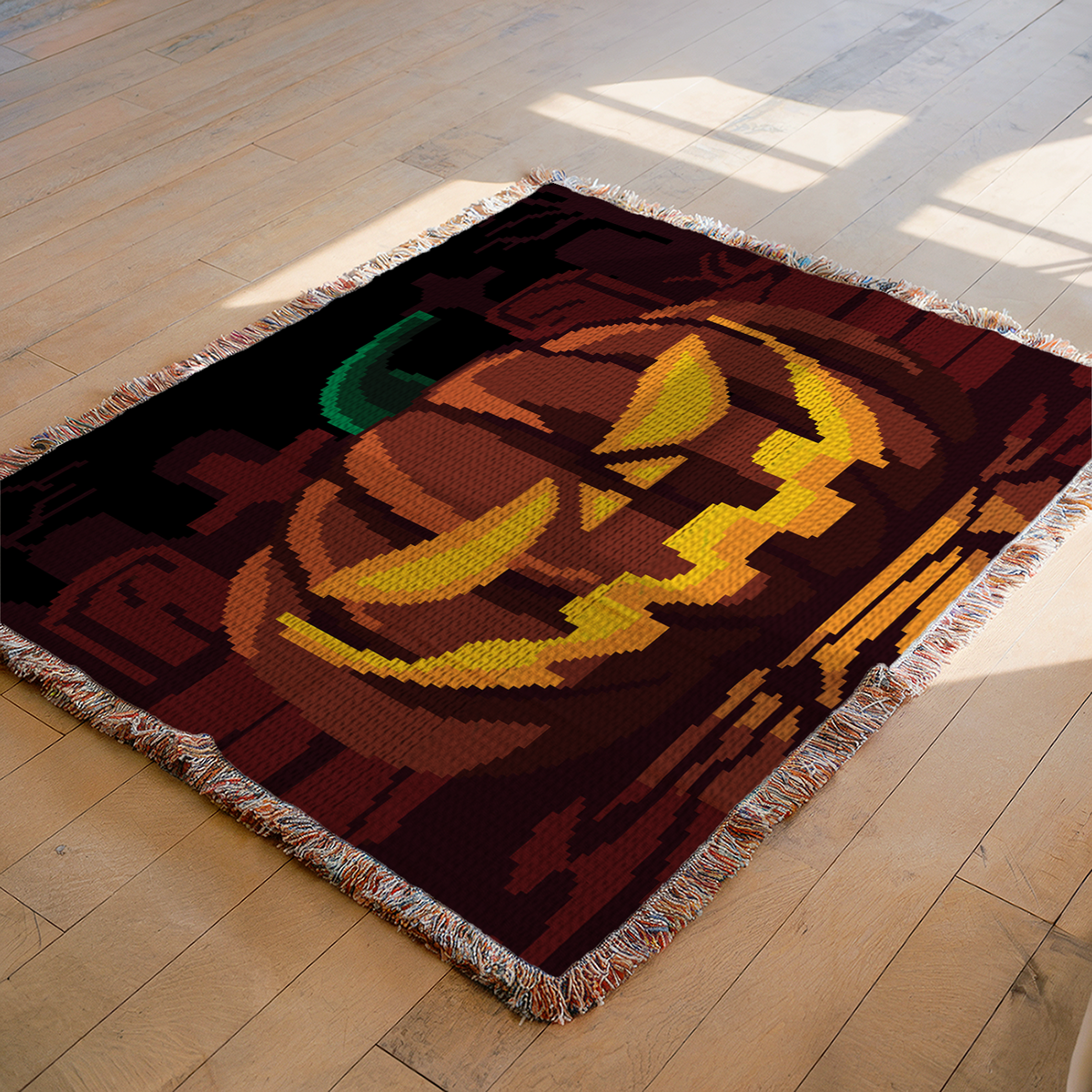 Pumpkin on a Graveyard C2C crochet blanket mockup featuring a glowing jack-o-lantern in a dark cemetery scene.