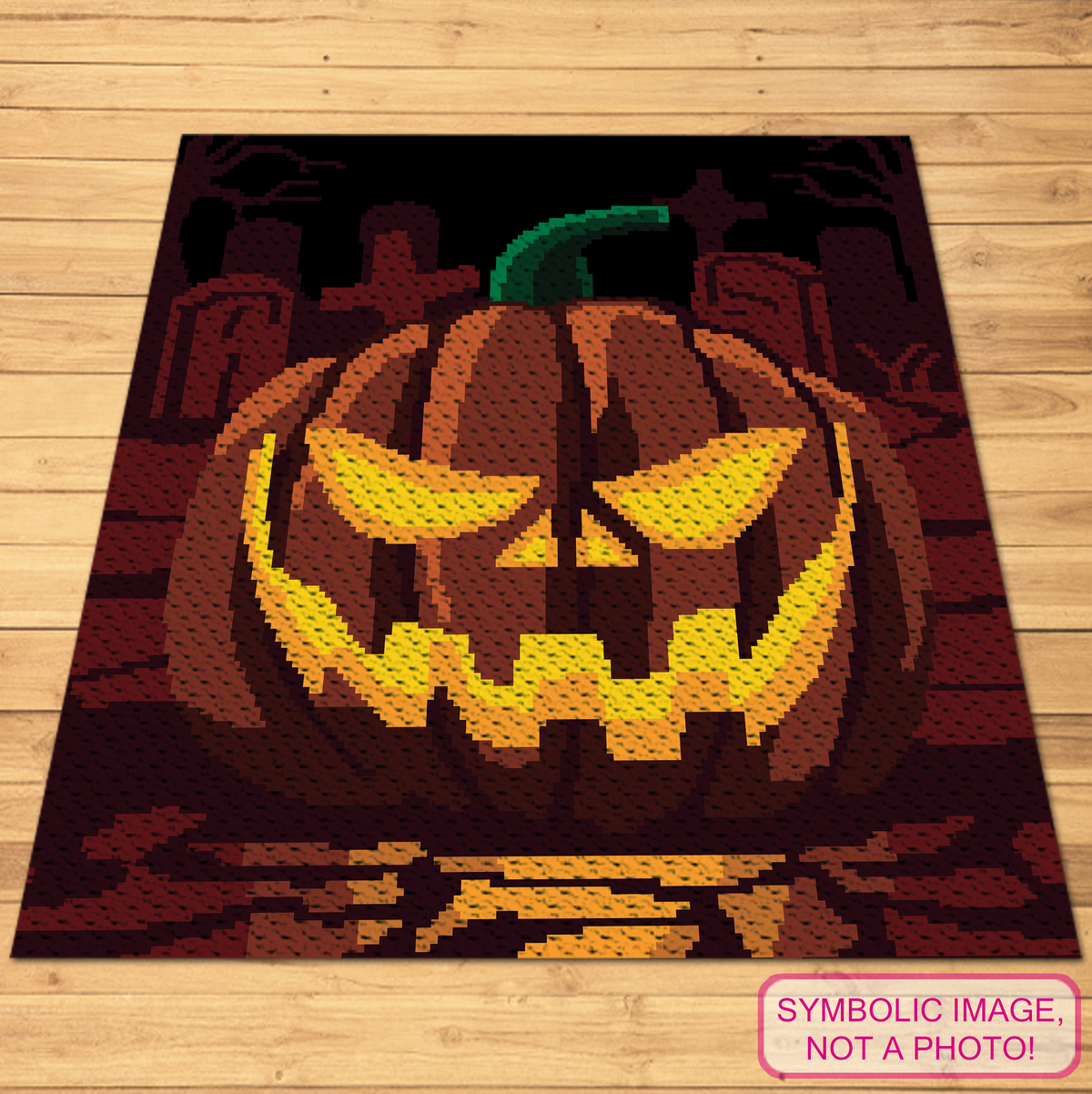 Pumpkin on a Graveyard C2C crochet blanket mockup shown flat on a wooden background.