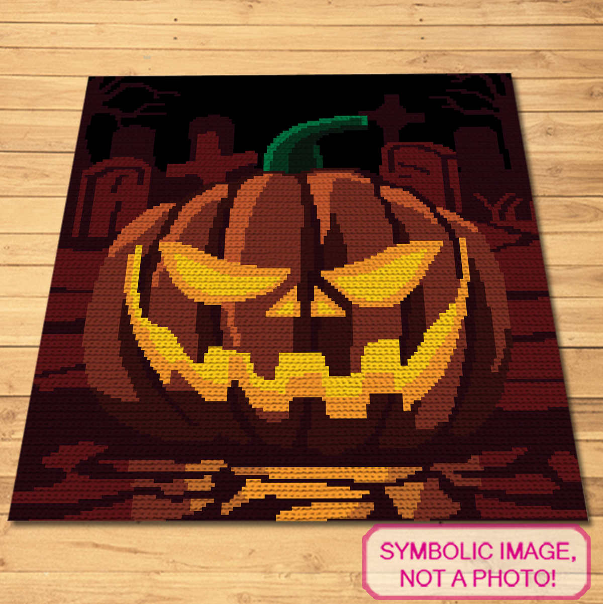 Pumpkin on a Graveyard crochet blanket mockup shown flat on a wooden background.