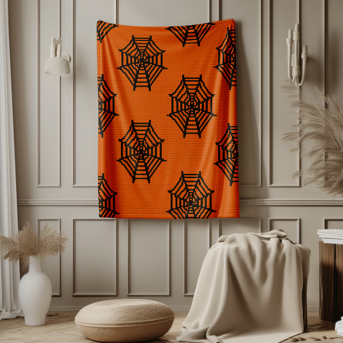 Orange spider web Halloween crochet blanket displayed as wall decor
